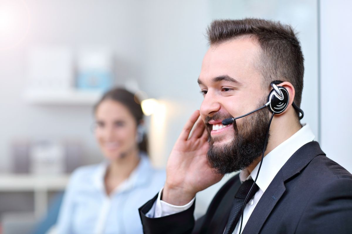 Picture showing happy man in call center